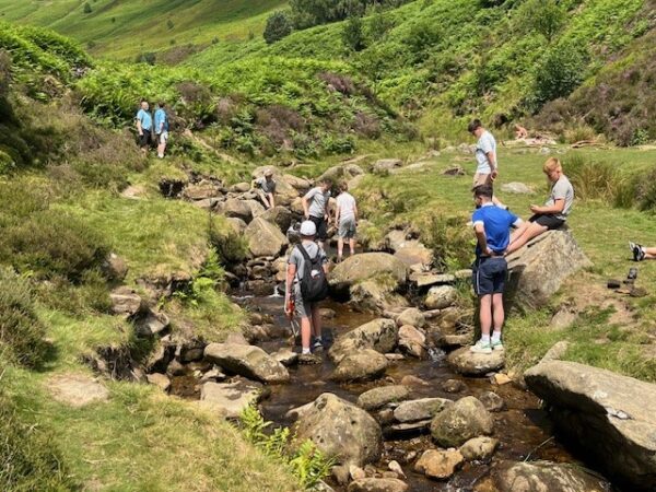 students walking on stepping stones