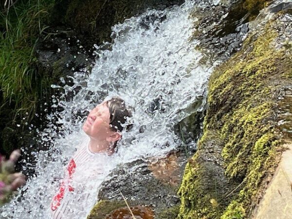 student in waterfall