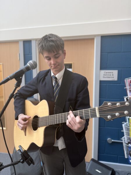 Y10 student playing guitar