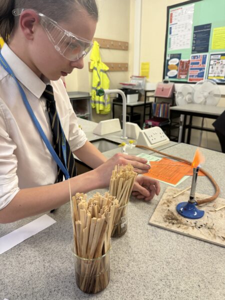 student using bunsen burner