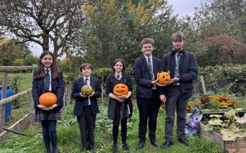 Eco club students holding pumpkins