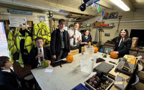 Eco club students carving pumpkins