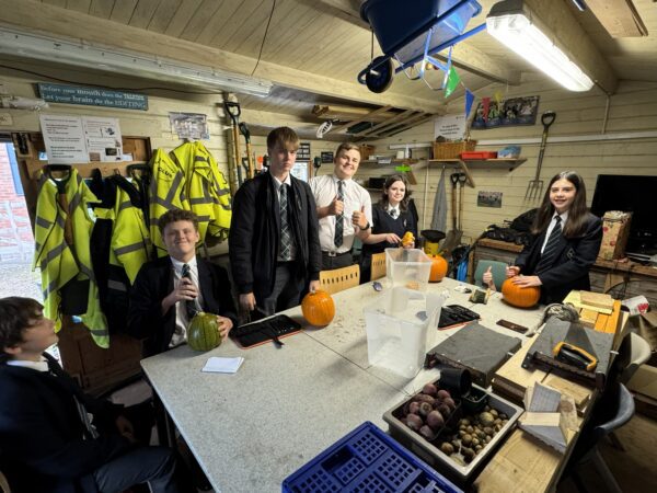Eco club students carving pumpkins