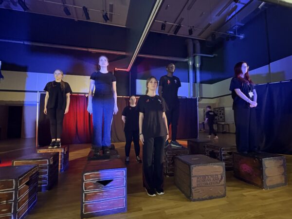 Drama students on wooden blocks