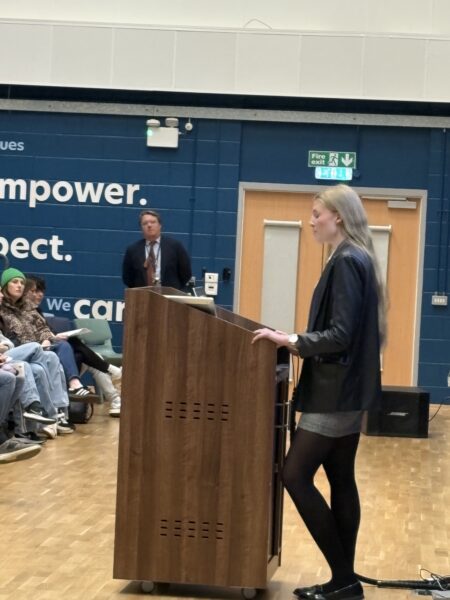 female students giving a speech at lectern