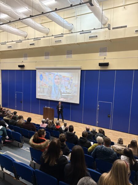 post 16 teacher giving presentation in main hall