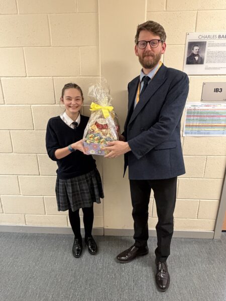 charity day competition winner with easter egg presented by teacher
