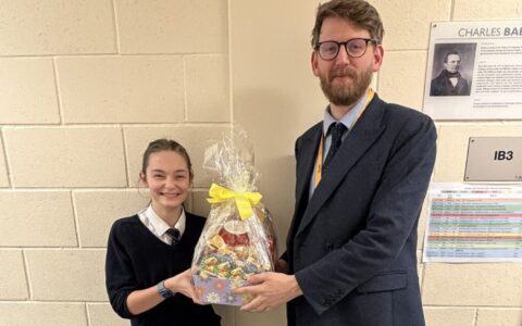 charity day competition winner with easter egg presented by teacher